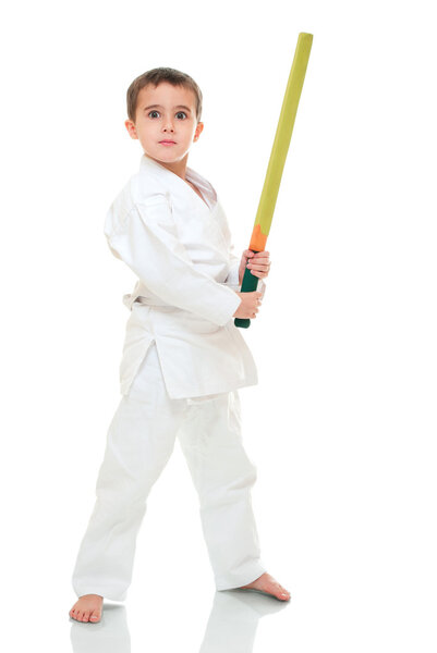Karate boy with toy sword in white kimono