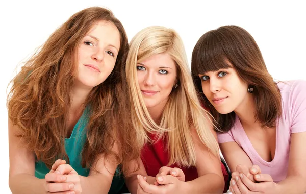 Three beautiful brunette, blonde and redhead girls lying down — Stock Photo, Image