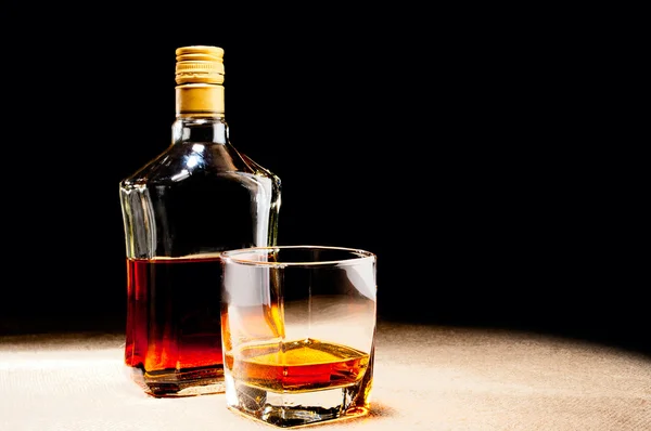 stock image Glass of whisky and bottle