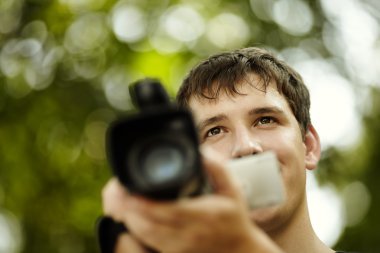 Young man with camcorder clipart