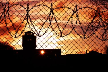 Sunset over prison yard clipart