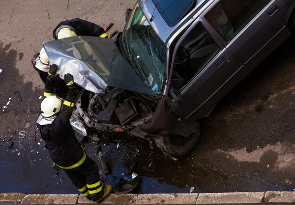 stock image Firemen checking crashed car