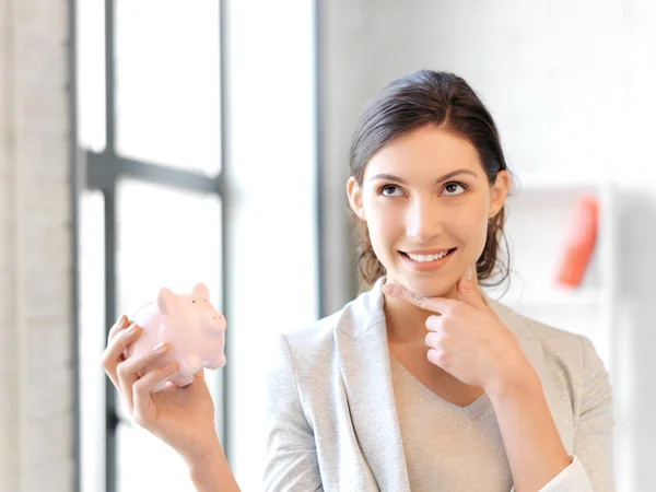 Schöne Frau mit Sparschwein — Stockfoto