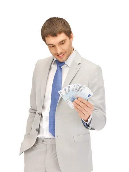 Hombre guapo con dinero en efectivo en euros — Foto de Stock