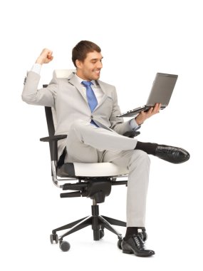 Young businessman sitting in chair with laptop clipart