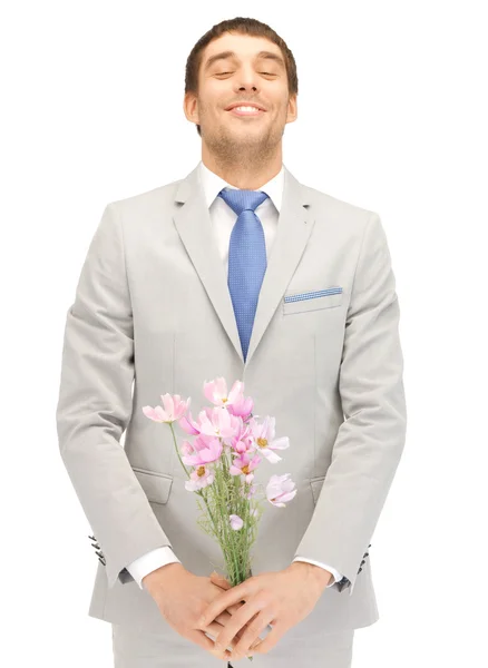 Handsome man with flowers in hand — Stock Photo, Image