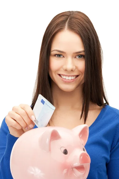 Lovely woman with piggy bank and money — Stock Photo, Image