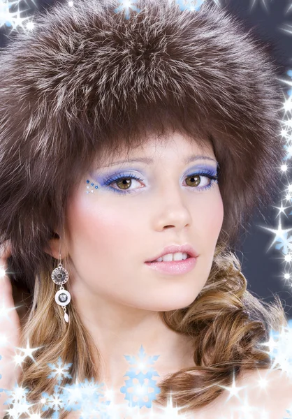 Lovely woman in furry hat over grey — Stock Photo, Image
