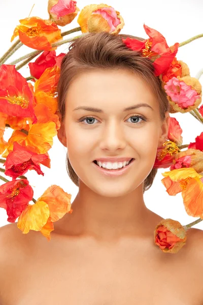 Lovely woman with red flowers — Stock Photo, Image