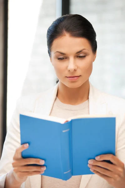 Calm and serious woman with book — Stock Photo, Image