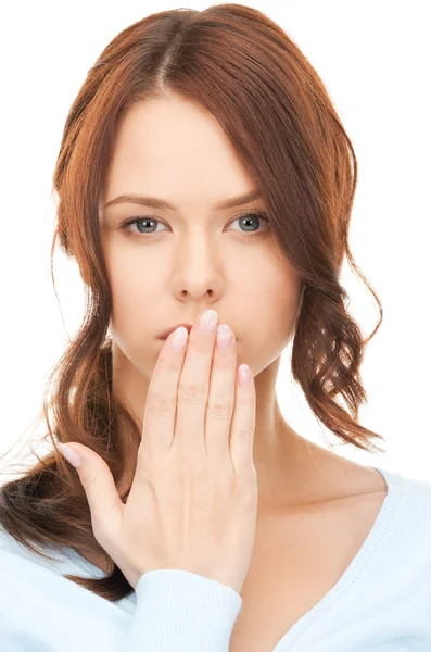 Woman with hand over mouth — Stockfoto