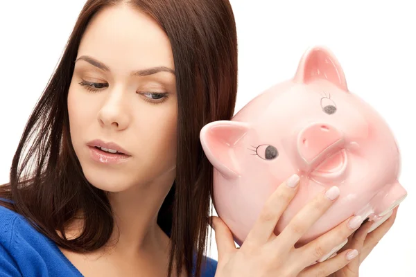 Lovely woman with piggy bank Stock Photo
