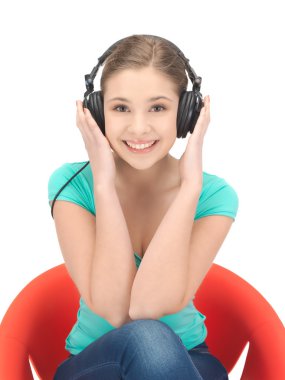 Happy teenage girl in big headphones clipart