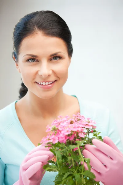 Lovely housewife with flower — Stock Photo, Image