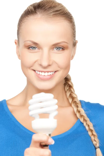 Mulher segurando lâmpada de poupança de energia — Fotografia de Stock