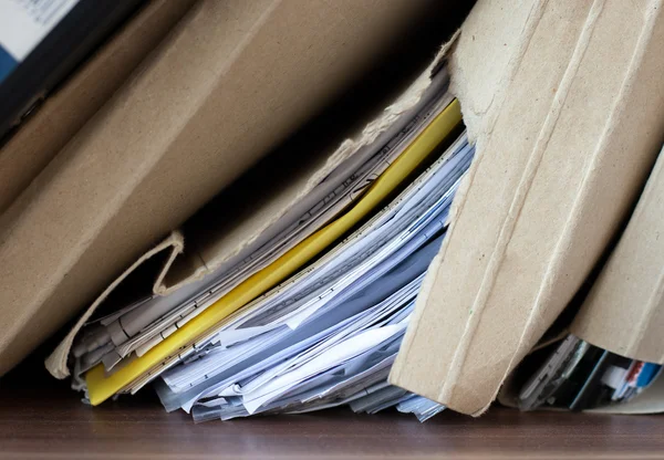 Torn cardboard folder with papers — Stock Photo, Image