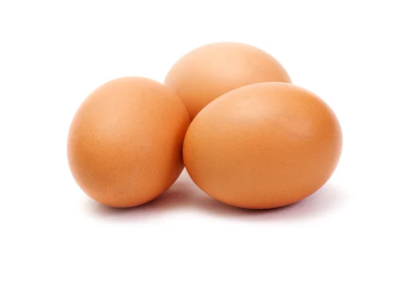 Stock image Three brown eggs on white background