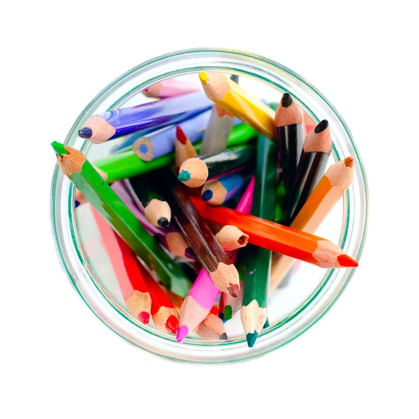 Colored pencils in a clear glass jar. top view — Stock Photo, Image