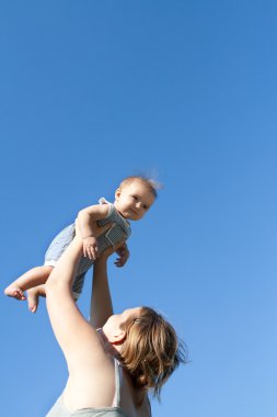 Mother throwing up her baby girl