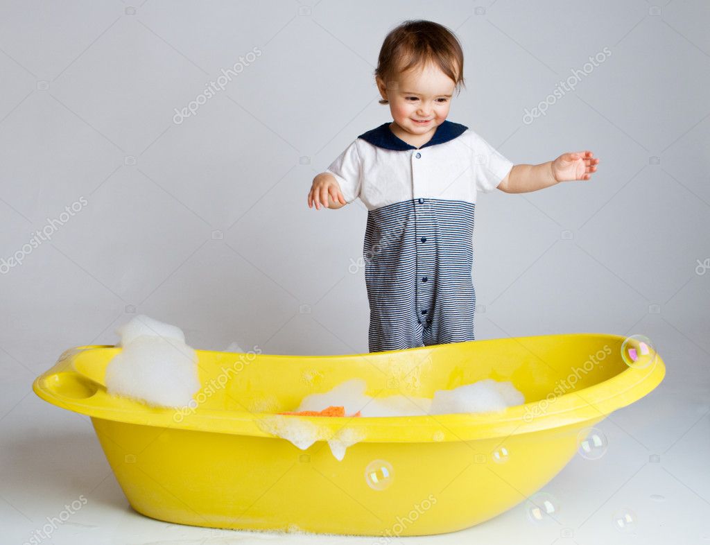 Charming baby standing near bathtub — Stock Photo © anatols 8636475
