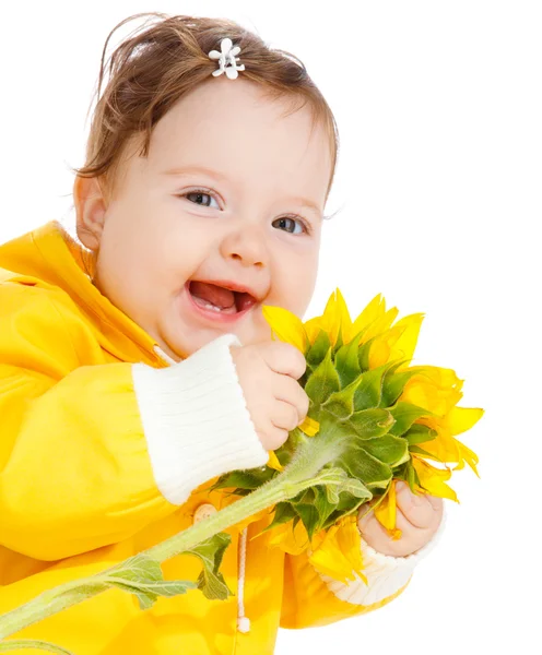 Laughing baby with sunflower — Stock Photo, Image