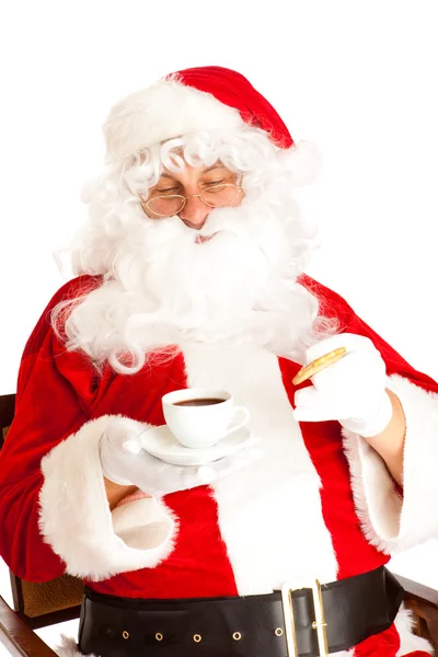 Kerstman houden van koffie en koekjes — Stockfoto