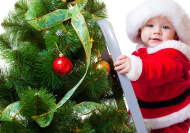 Baby in Santa costume on a step ladde clipart