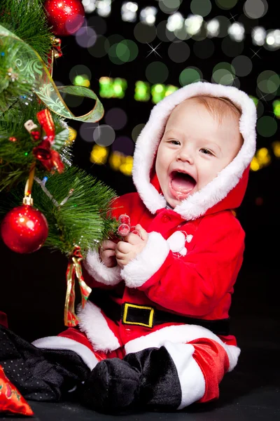 Santa helper decorating Christmas tree — Stock Photo, Image