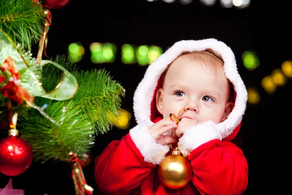 Baby beside Christmas tree — Stock Photo, Image