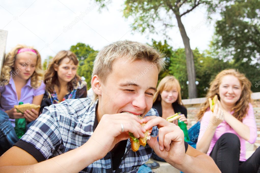Guy biting sanwich