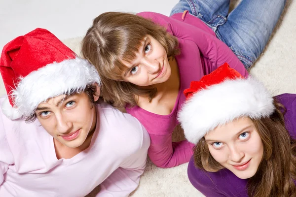 Teenage friends in Santa hats — Stock Photo, Image