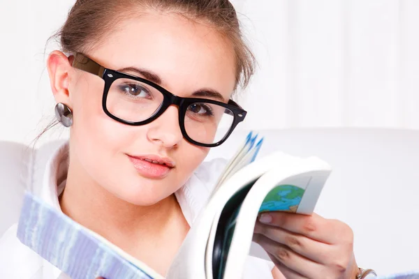 Young woman in glasses reading — Stock Photo, Image