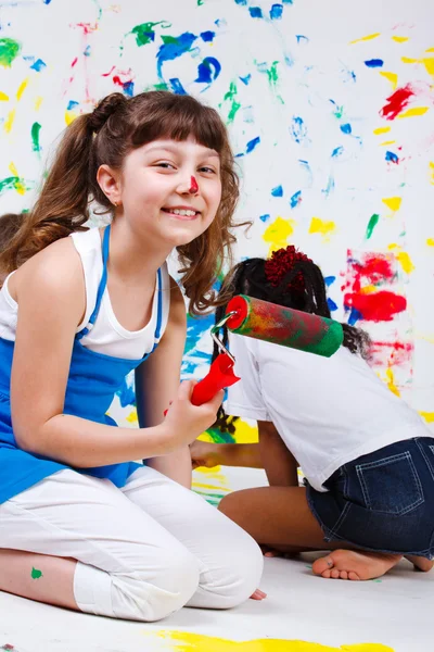 Junior student holding paint roller — Stock Photo, Image