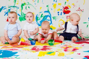 Babies playing with paints clipart
