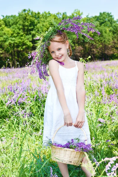 Mädchen hält Korb mit Blumen — Stockfoto