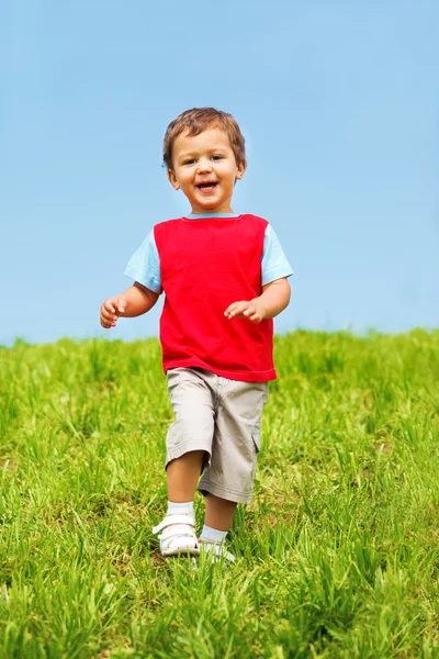 Смеющийся мальчик бежит — стоковое фото