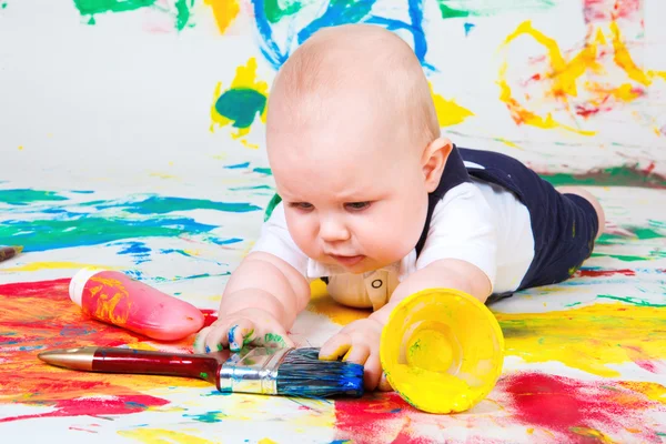 Infant playing with paintbrush — Stock Photo, Image