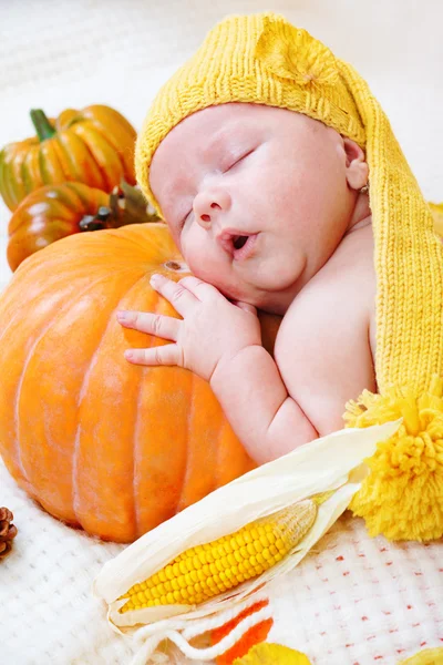 Baby sleeping on a pumpkin — Stock Photo, Image