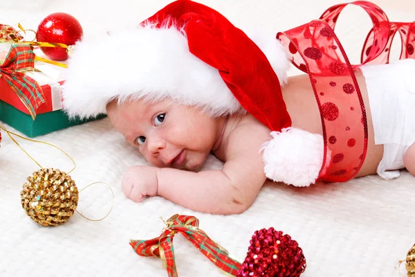 Sweet baby in Christmas hat — Stock Photo, Image