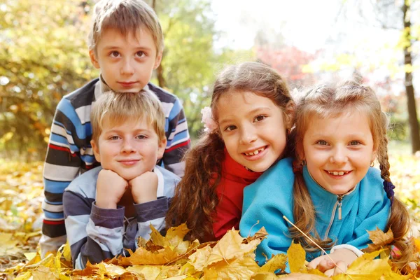 Girls and boys in autumnal park — Stock Photo, Image