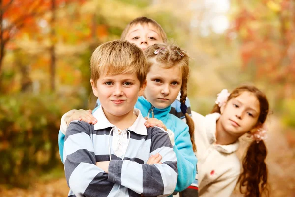 Boys and girls in autumn — Stock Photo, Image
