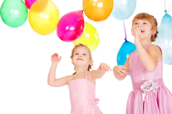 Sisters playing with balloons — Stock Photo, Image