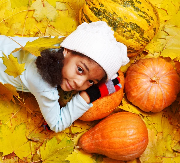 African american girl lying on pumpkin — Stock Photo, Image
