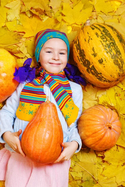 Smiling girl with pumpkin — Stock Photo, Image