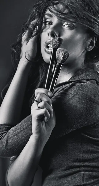 Portrait of a woman with brushes — Stock Photo, Image