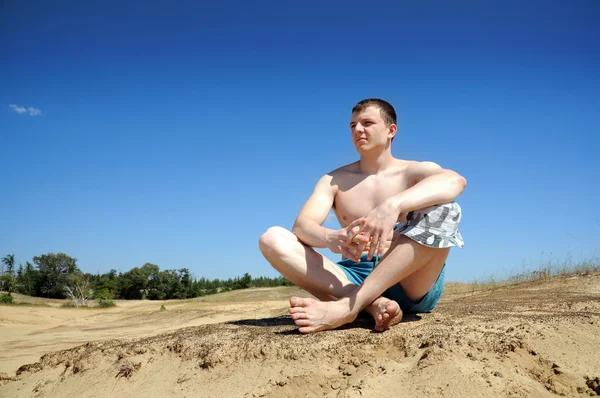 Young man in lotus position — Stock Photo, Image