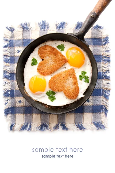 Fried eggs with slices of bread in the shape of a heart — Stock Photo, Image