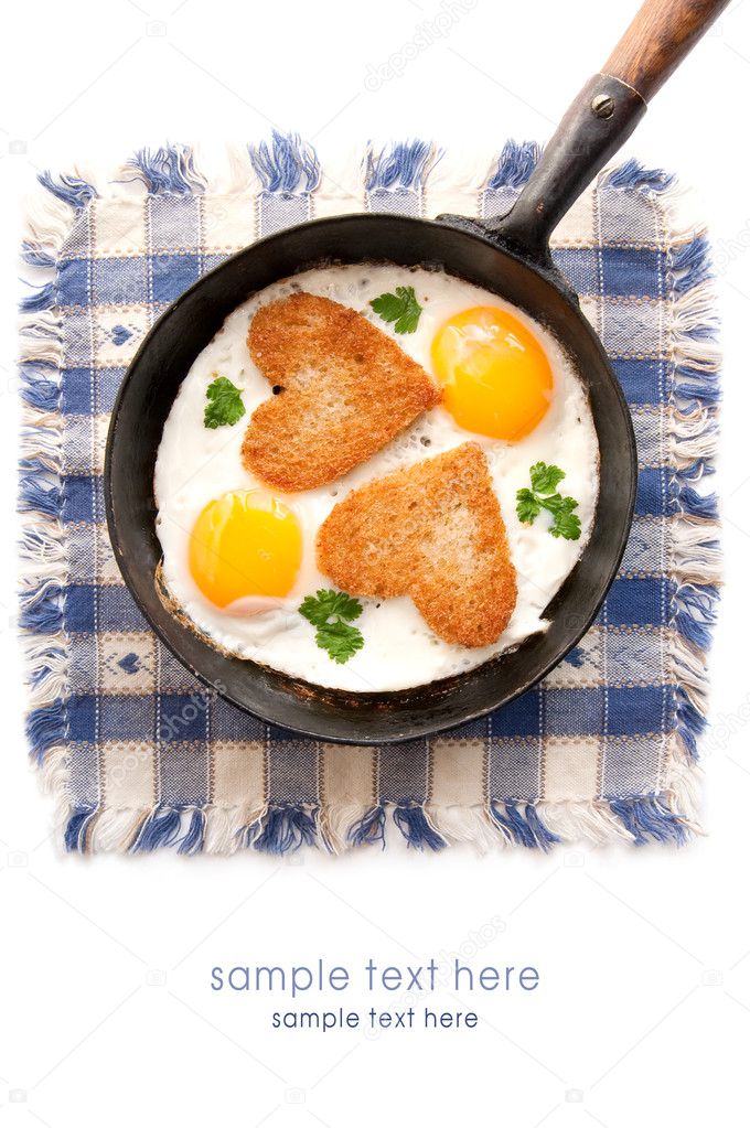 Fried eggs with slices of bread in the shape of a heart