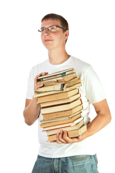 Jovem segurando pilha de livros — Fotografia de Stock