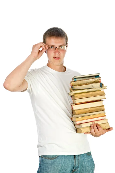 Młody człowiek posiadający stos książek — Zdjęcie stockowe